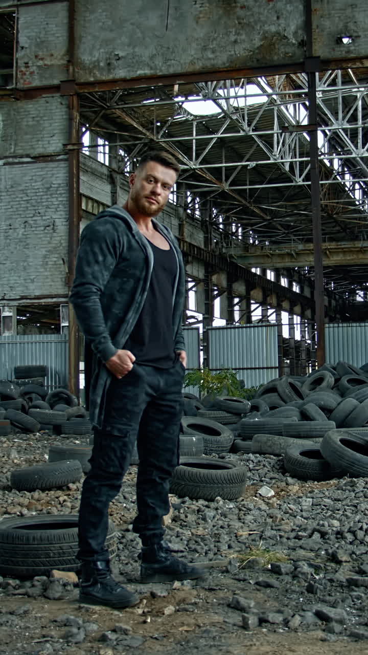 Man standing in ruined building. Young man posing in abandoned building