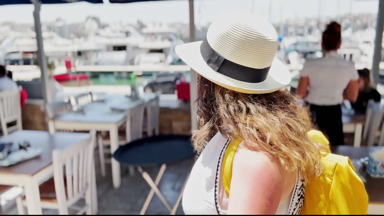 Woman enjoying a meal at a waterfront cafe