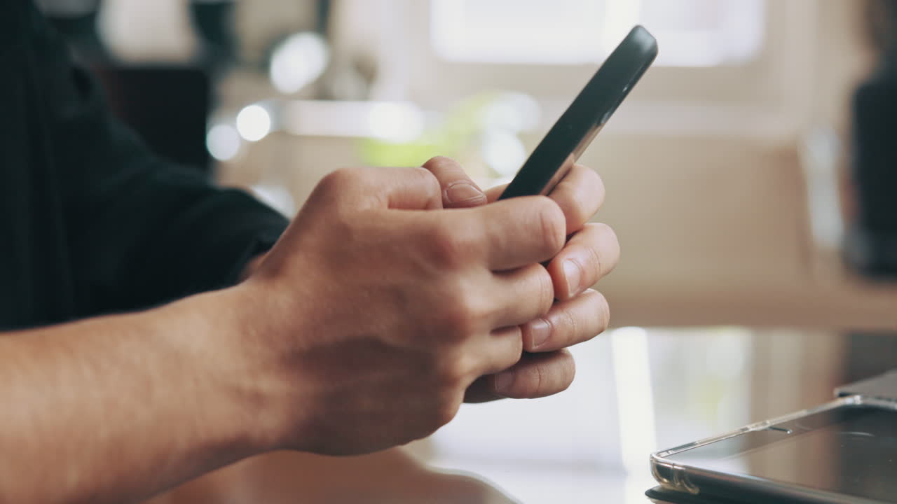 Close-Up of Hands Using a Smartphone for Scrolling and Typing