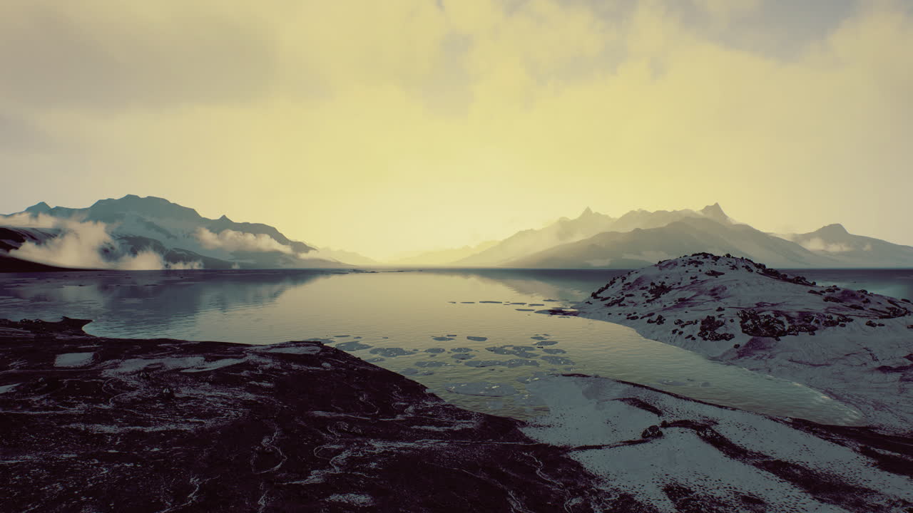 Serene twilight over a tranquil lake surrounded by majestic mountains