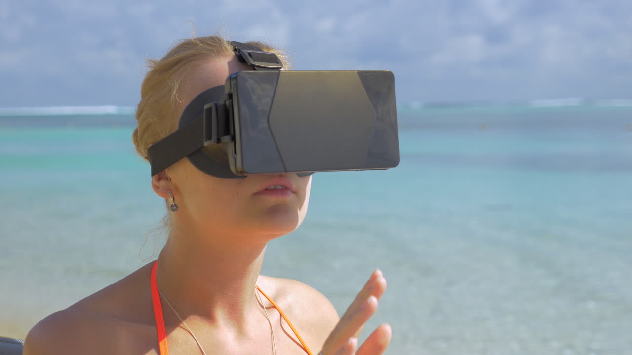 mujer usando auriculares vr en la playa