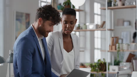 african american business woman team leader brainstorming with colleague using laptop computer showing ideas pointing at screen working together in office