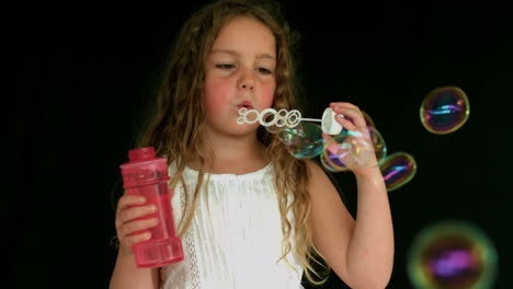 little girl making bubbles