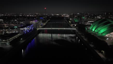 city nighttime scene, dark river clyde waters, illuminated footbridge