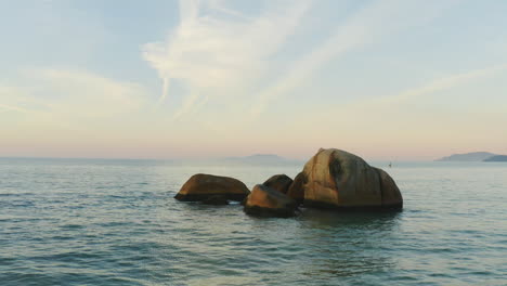 beautiful aerial drone view sunset of big rocks in the ocean