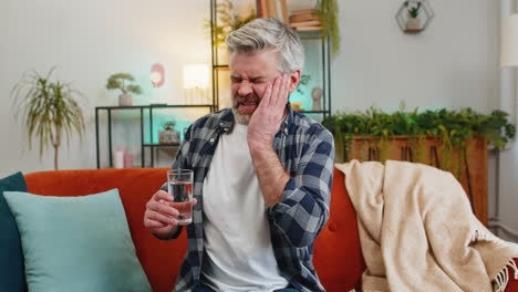 senior middle aged man feel terrible toothache after drink cold water sensitive tooth pain cavities