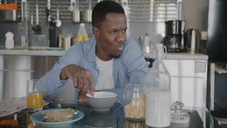 man eating breakfast in kitchen