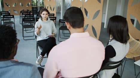 group of young people listening young woman