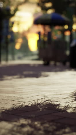 a blurry image of a street at sunset with shadows on the pavement