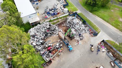 aerial view of scrapyard with active machinery