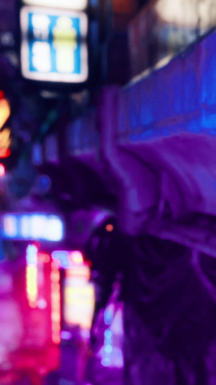 Neon lights illuminate city streets during the night in a busy urban area