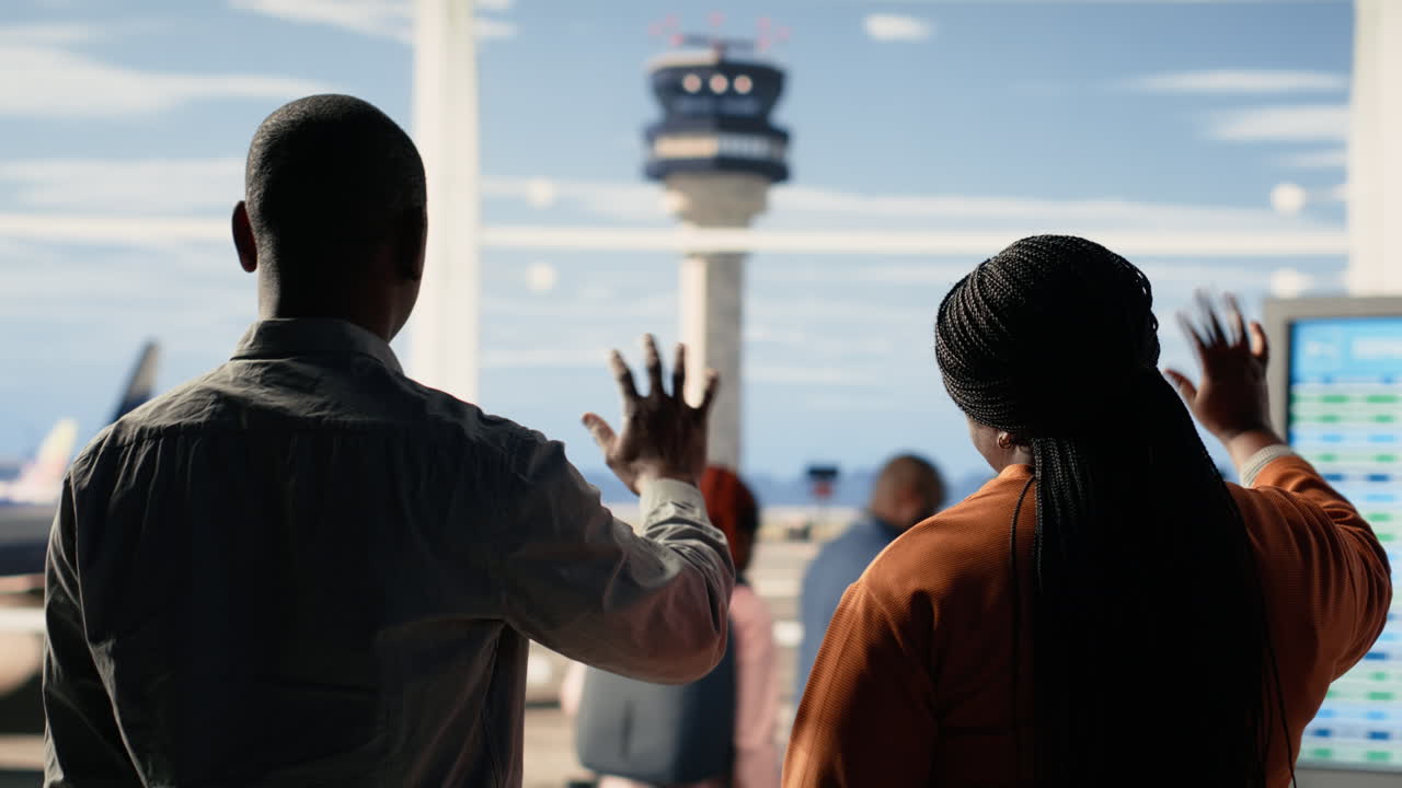 Waving goodbye at airport, sad mother and father, daughter studying abroad