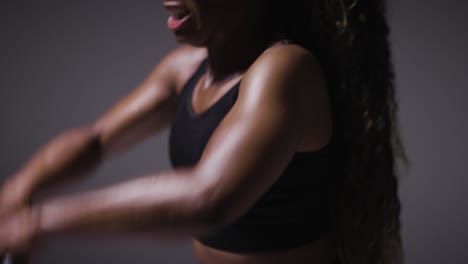 Studio-Shot-Of-Woman-Wearing-Gym-Fitness-Clothing-Exercising-With-Kettlebell-Weights-4