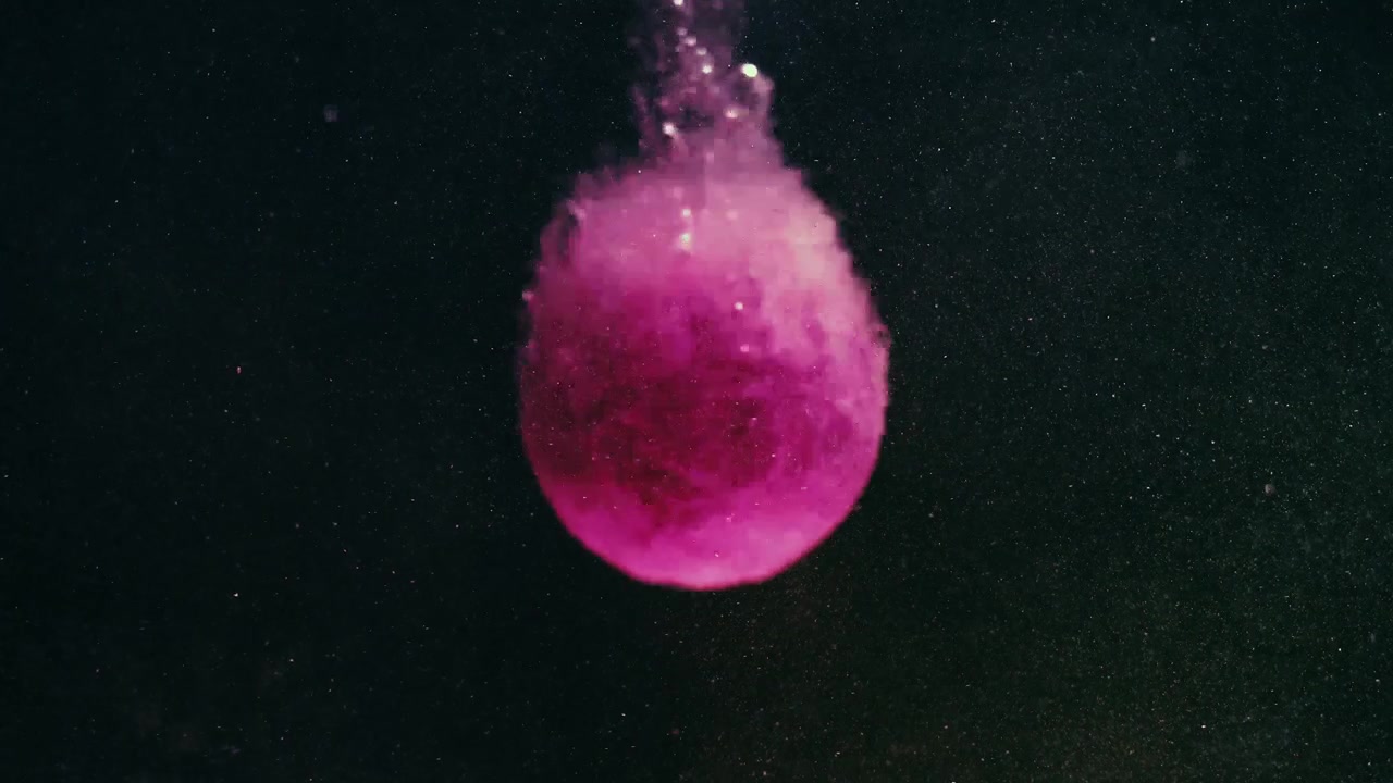 Bathbomb sinks in water and bubbles.