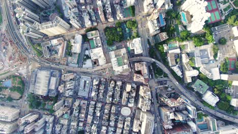 Central-Hong-Kong,-top-down-aerial-view-of-traffic-and-city-skyscrapers