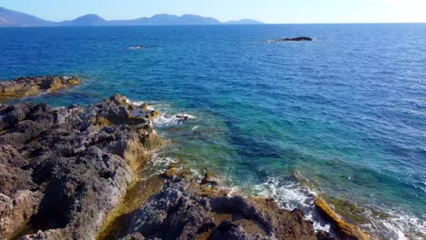 rocky shore with salt pools on the brink of open sea