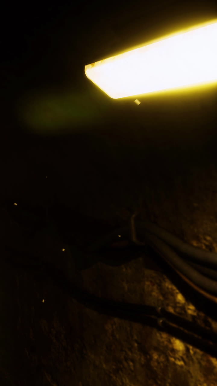 Quiet glow revealing hidden wires in a dim space during nighttime