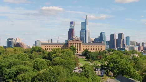 museum of art in philadelphia, with skyscrapers and city hall in the background