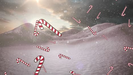 multiple candy cane icons and snow falling over winter landscape against clouds in the sky