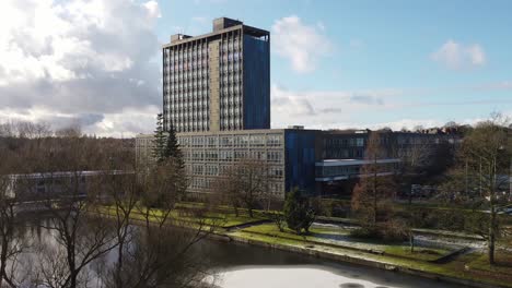 Snowy-Pilkingtons-glass-head-quarters-blue-high-rise-business-office-park-rising-aerial-view