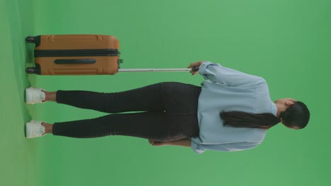 woman with luggage on green screen