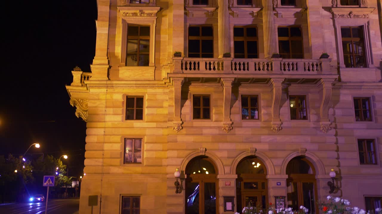 Exterior Of A Building Illuminating At Night With A Beautiful Garden Landscape In Prague, Czech Republic. - pan down