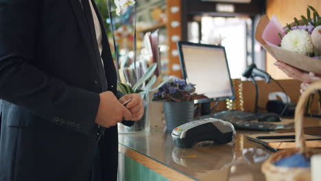 customer paying for flowers at a florist shop