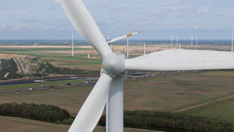 close up to spinning wind turbine at wind park