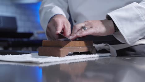 Chef Sharpening Knife on Whetstone