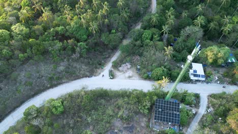 drone fly above jungle hill solar houses, roads, motorbikes in koh tao thailand