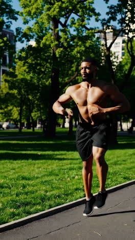 man jogging shirtless in a park