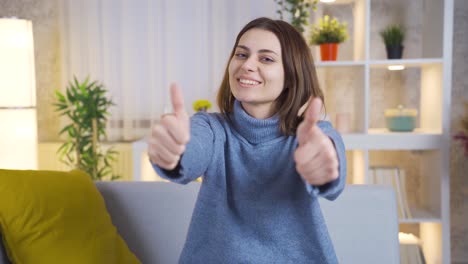 Satisfied-cheerful-young-woman-looking-at-camera-and-making-ok-sign.