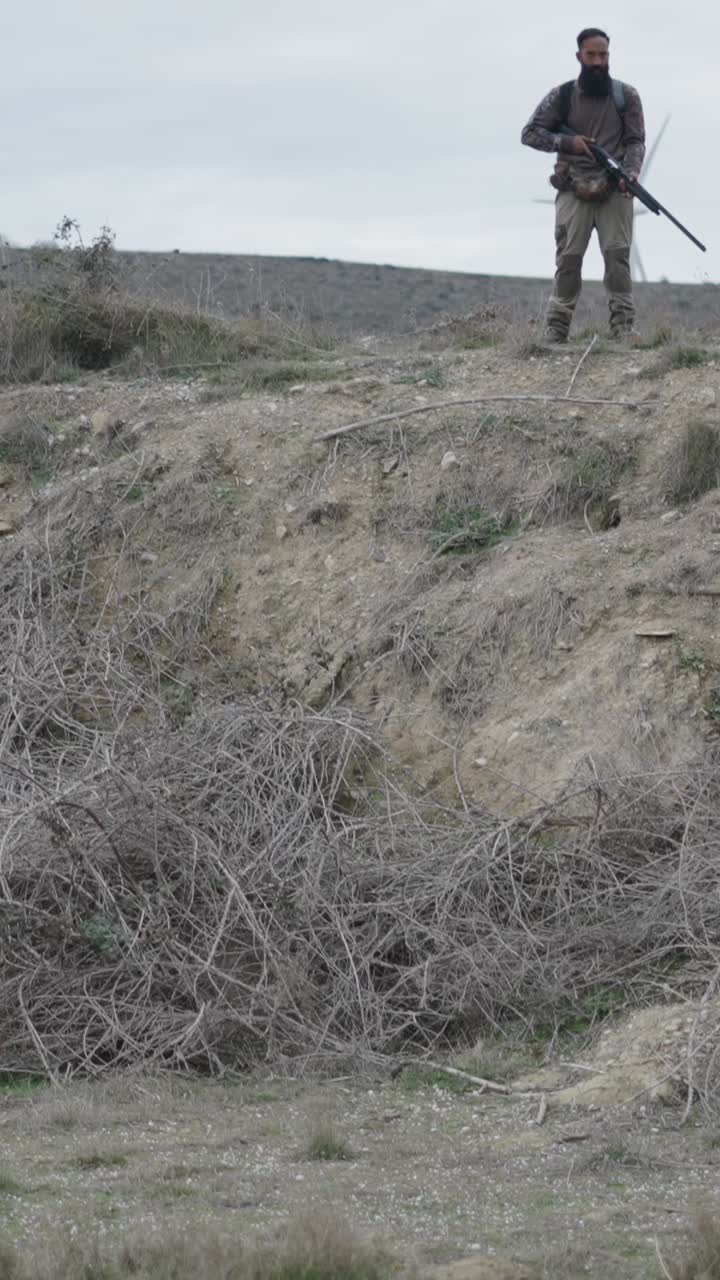 Man with rifle on a hill