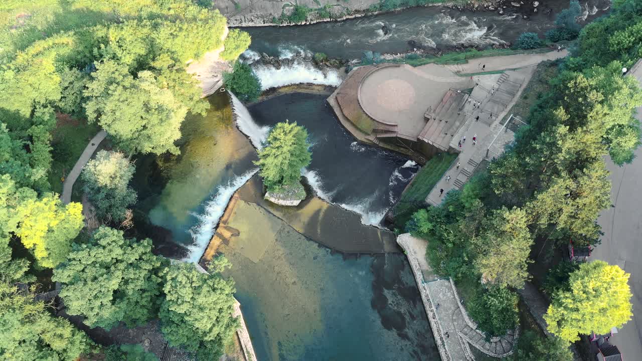 Wide angle aerial drone shot of beautiful Provalije Waterfall and surrounding landscapes in the pocitelj castle, Mostar city during the day