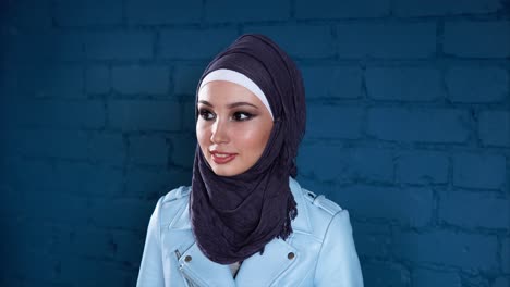 young woman in hijab and blue jacket