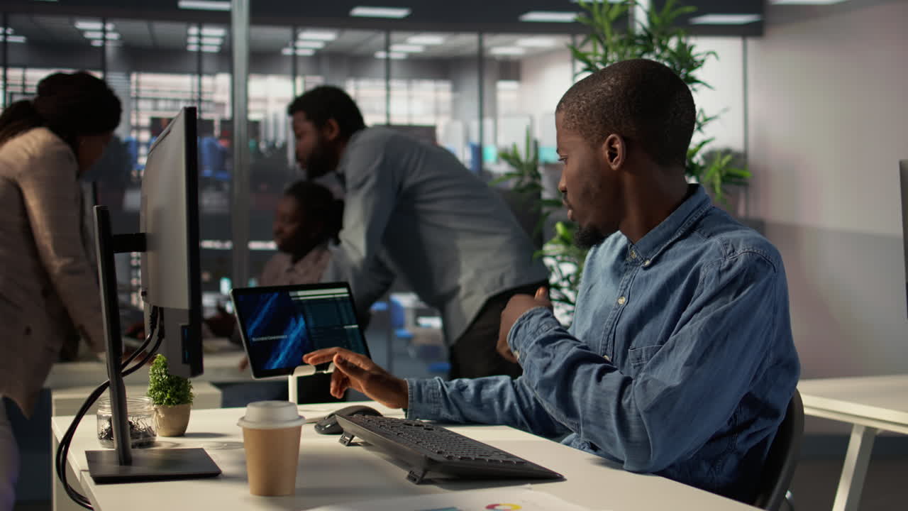 Business Person Working on Tablet and Computer in Office
