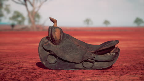 old decorated mexican saddle lying on sand