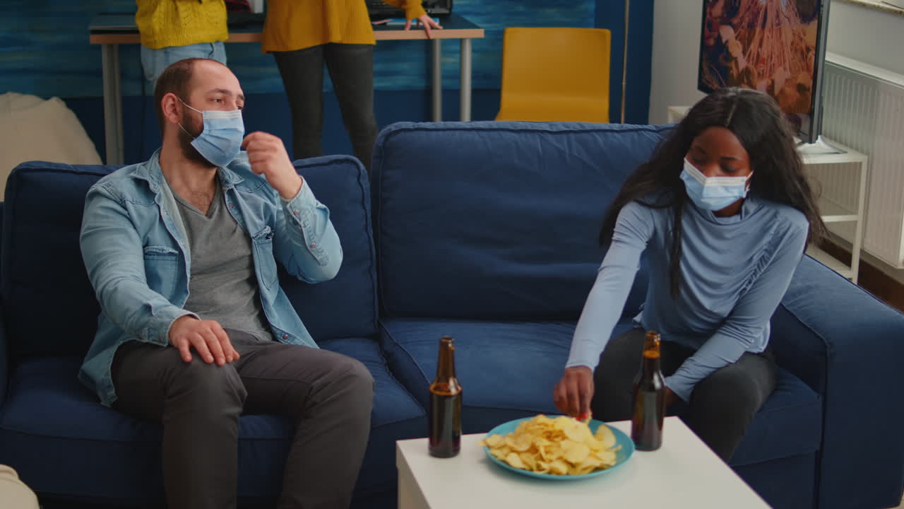 Group of diverse friends with mask meeting in home living room