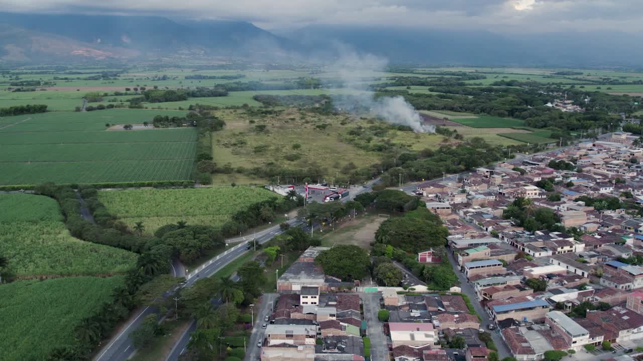 Aerial drone footage of El Cerrito Valle del Cauca Colombia showing urban houses on the right and farmland on the left
