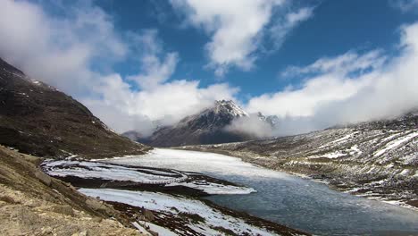 time lapse of snow cap mountains with frozen lake and bright blue sky at morning from flat angle video is taken at sela tawang arunachal pradesh india