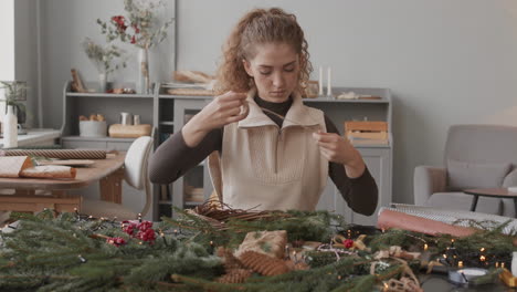 woman making christmas wreath