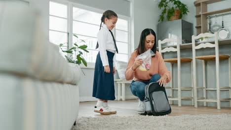 school, child and mother packing a bag at home