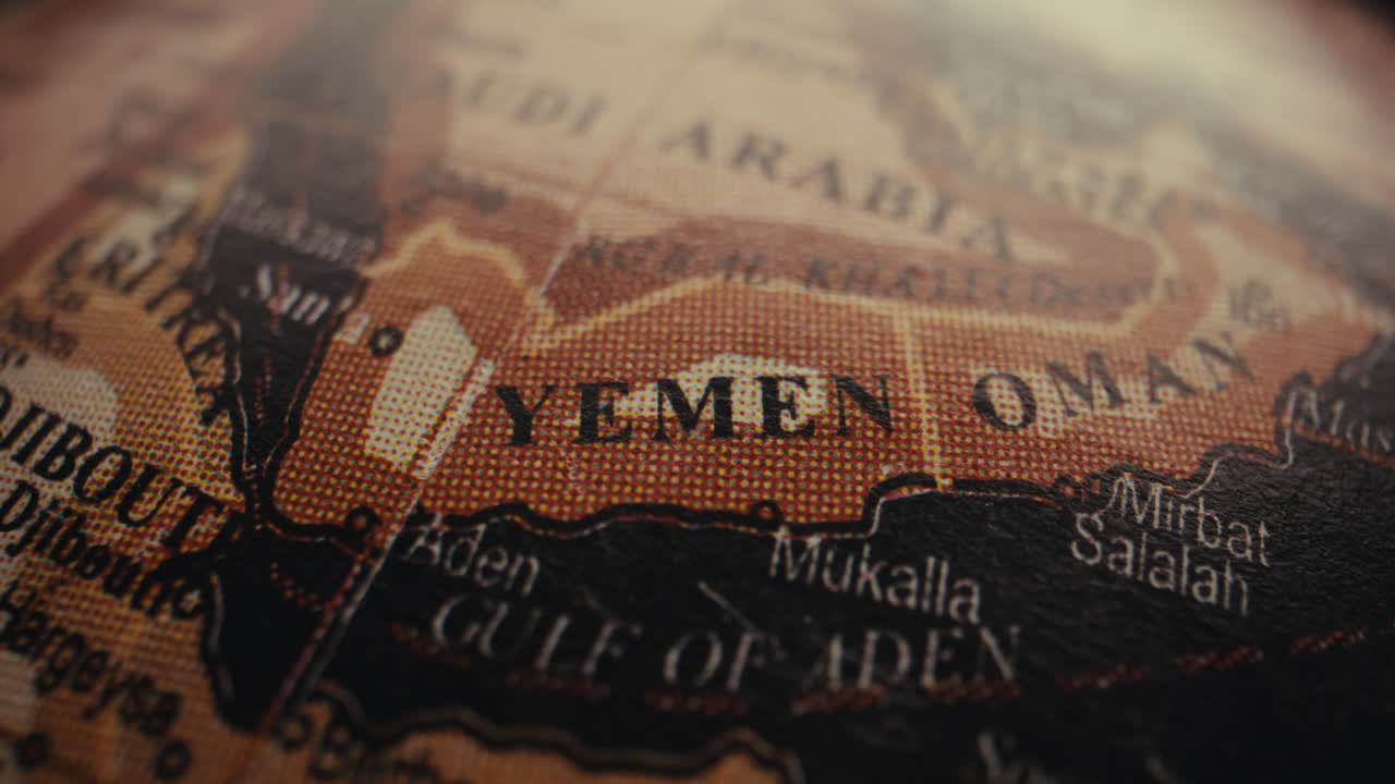 Close-up of a vintage world globe, focusing on Yemen and Oman.