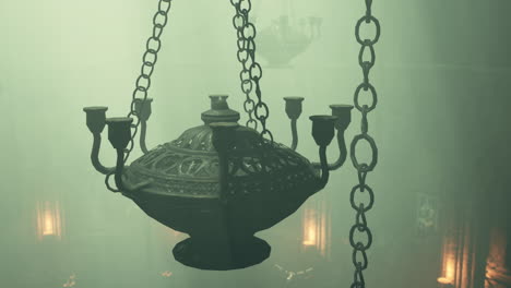 ancient chandelier hanging in a foggy, mysterious setting