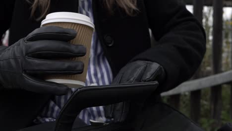 business woman with briefcase and takeout coffee close up shot
