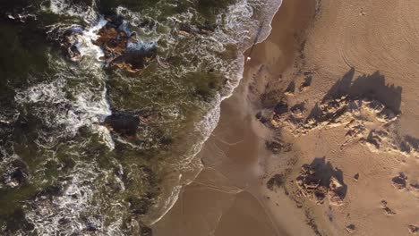 One-person-strolling-on-sandy-beach-at-sunrise,-Punta-del-Este-in-Uruguay