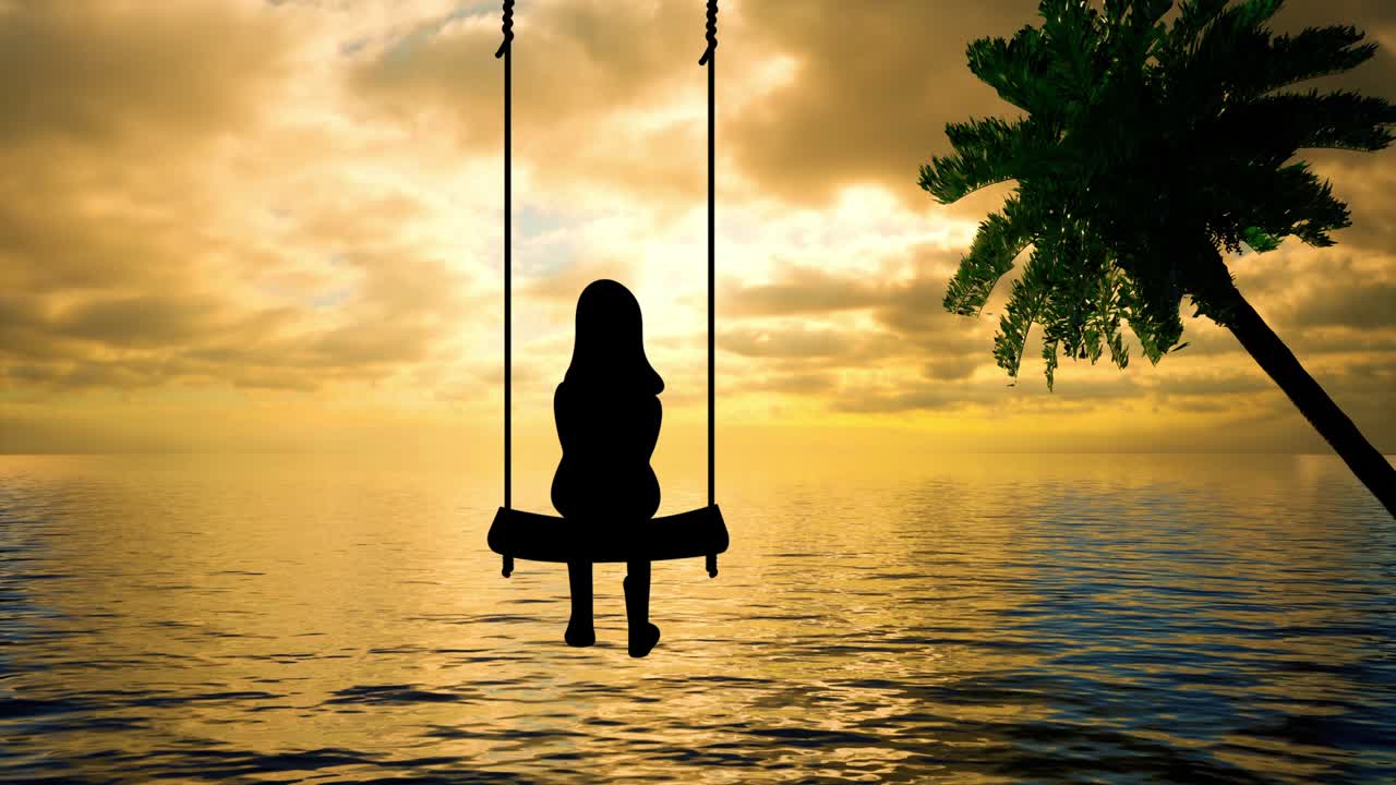 The silhouette of a young person on a swing watching the sun setting over the ocean horizon