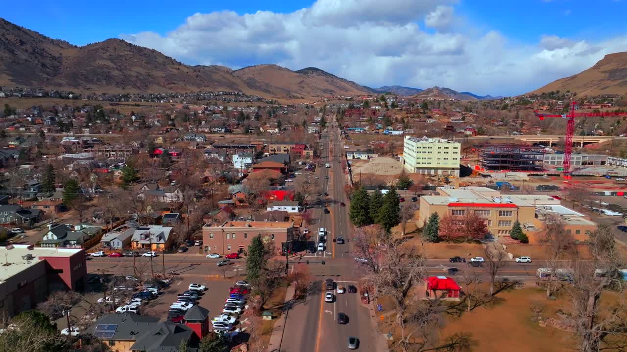 Golden Colorado aerial drone Historic downtown Golden Gate Canyon winter sunny morning afternoon blue sky Highway 93 Boulder Flat Irons Clear Creek River Canyon crane buildings cars forward motion