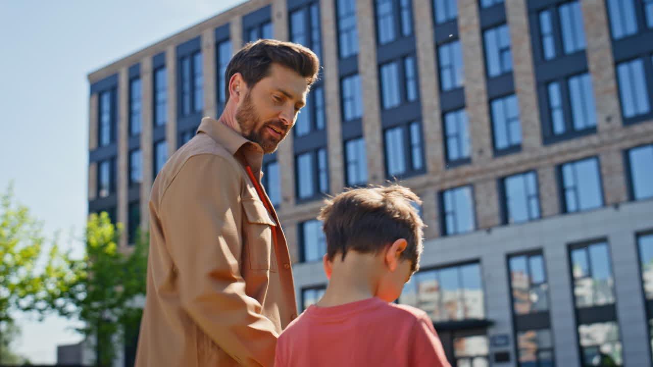 Father child leisure together nature closeup. Family legs stepping green grass