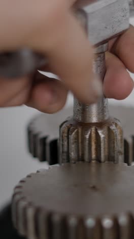 close-up of a hand operating metal gears